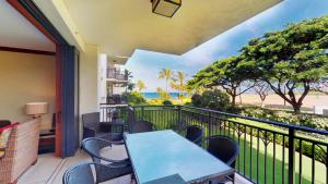 a balcony with a table and chairs and a view of the ocean at Ko Olina Beach Villas B204 in Kapolei