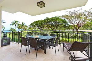 a patio with a table and chairs on a balcony at Ko Olina Beach Villas B204 in Kapolei +63 photos