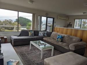 a living room with a couch and a coffee table at The Castle - Goolwa Beach in Goolwa South