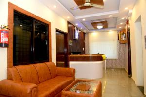 a living room with a couch and a table at Hotel Aradhya Inn Deralakatte in Mangalore