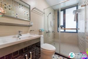 a bathroom with a toilet and a sink and a shower at Baby Dolphin in Hengchun