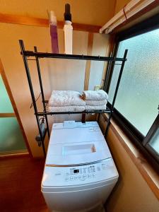 Postel nebo postele na pokoji v ubytování ゲストハウス 畔（hotori）