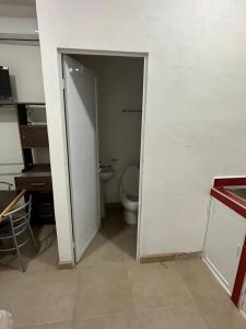 an open door to a bathroom with a toilet at Departamento Diegos cabo in Cabo San Lucas