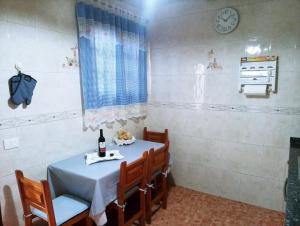 a dining room with a table and chairs and a clock at LA CASA DE PÁ in Vega de San Mateo