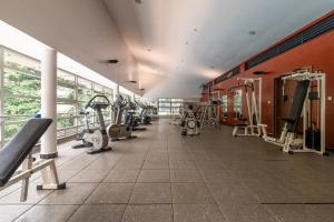 a gym with several treadmills and machines at Riverside Hidden Oasis By YourHost 3 Bed in Nairobi