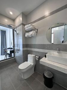 a bathroom with a white toilet and a sink at Ana's House in Quy Nhon