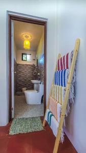 a bathroom with a ladder and a bathroom with a sink at EspIliNorte, Stay and Play in San Juan