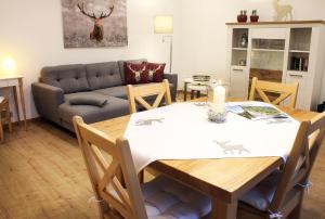 a living room with a table and a couch at Haus Hildegard in Zwiesel