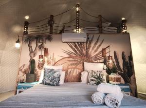 a bedroom with a canopy bed with plants on it at Sun&Sand Camps Bay in Cape Town