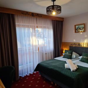 Una cama o camas en una habitación de Willa u Kośle Zakopane