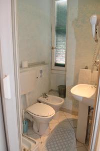 a bathroom with a toilet and a sink at Albergo Belvedere in Acqui Terme