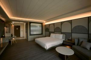 Posteľ alebo postele v izbe v ubytovaní XIUXI Anping Hotel