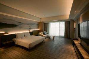 Posteľ alebo postele v izbe v ubytovaní XIUXI Anping Hotel