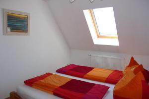 two beds in a room with a window at Ferienwohnung Luv - direkt am Salzhaff in Rerik