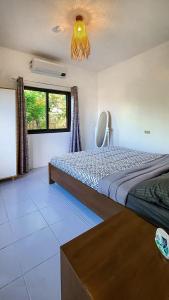 a bedroom with a large bed and a window at EspIliNorte, Stay and Play in San Juan