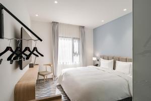 Postel nebo postele na pokoji v ubytování Phoenix Hotel Taichung