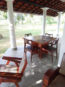 a wooden table and chairs on a patio at Antique Villa in Ranna