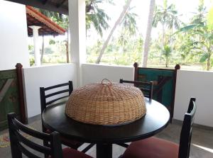 a rattan basket sitting on a table on a porch at Antique Villa in Ranna +12 photos