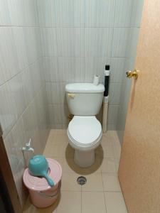 a bathroom with a toilet in a small stall at Majuro see breeze suites in Majuro