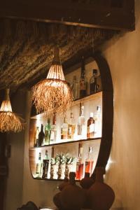 a room with a shelf with bottles on the wall at LUCKY'S in Gili Air