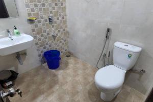 a bathroom with a white toilet and a sink at 2bhk cozy apt near baina beach in Vasco Da Gama