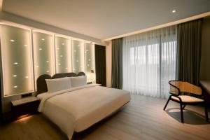 Posteľ alebo postele v izbe v ubytovaní XIUXI Anping Hotel