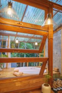 a bath tub in a room with a window at Woo Ma Ca Moo in Chiang Mai