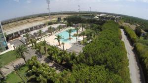 an aerial view of a resort with a pool and palm trees at Eureka Palace Hotel Spa Resort in Cassibile
