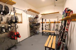 サースフェーにあるSonnenhügelの壁にスキー用具を備えた部屋