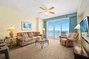 a living room with a couch and a large window at Beachfront Luxury Villa Ocean Walk Resort Daytona in Daytona Beach