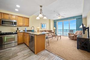 a kitchen and living room with a view of the ocean at Beachfront Luxury Villa Ocean Walk Resort Daytona in Daytona Beach