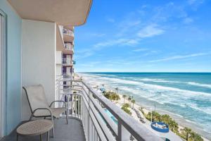 a balcony with chairs and a view of the ocean at Beachfront Luxury Villa Ocean Walk Resort Daytona in Daytona Beach