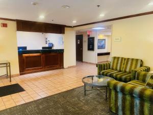 a lobby with two chairs and a table and a counter at Norwood Inn Statefare Grounds in Indianapolis