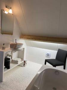 a bathroom with a sink and a bath tub at Begijnhofstudio's in Tongeren