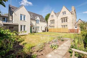 a large house with a yard in front of it at Abbey Villa - Stylish House - Central with Parking in St Andrews