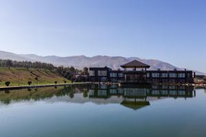 a large building sitting on top of a lake at Arman Dala Resort in Qaskeleng