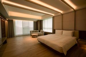 Posteľ alebo postele v izbe v ubytovaní XIUXI Anping Hotel