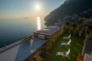 an aerial view of a house with a view of the water at Aria di Mare, garden and Sea View in Positano in Positano
