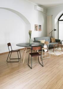 a living room with a table and a couch at ComeCasa Bright City Flat with Private Terrace in Milan