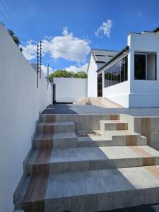 a white house with stairs in front of it at DBright Lodge in Pretoria