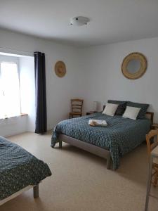 a bedroom with a bed and a window at Auberge de la vallée de la douve in L'Etang-Bertrand