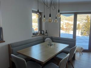 a dining room with a wooden table and chairs at Haus Schlatti in Altenmarkt im Pongau