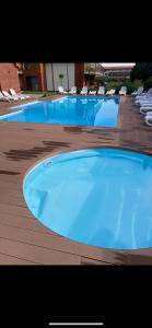 a large swimming pool with lounge chairs in a resort at Apartament 2B-5 Żarnowska in Żarnowska