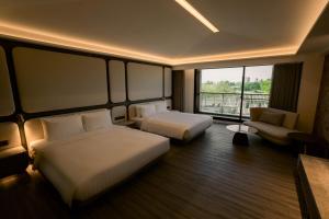 Posteľ alebo postele v izbe v ubytovaní XIUXI Anping Hotel