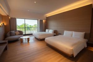 Posteľ alebo postele v izbe v ubytovaní XIUXI Anping Hotel