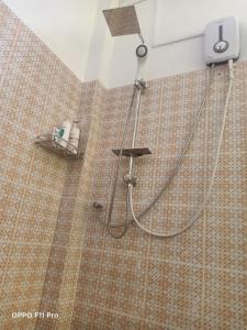 a shower with a hose in a bathroom at Homestay Yellow Natural House in Siem Reap +47 photos