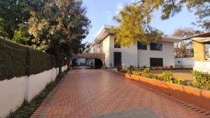 a brick road in front of a building with a tunnel at Aleph Islamabad Guest House in Islamabad