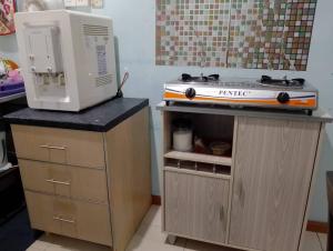 a pretend kitchen with a stove on top of a counter at Homestay Ainul in Pendang