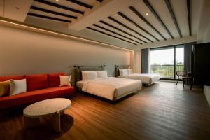 Posteľ alebo postele v izbe v ubytovaní XIUXI Anping Hotel