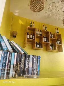 a shelf filled with books on a wall at Homestay Yellow Natural House in Siem Reap